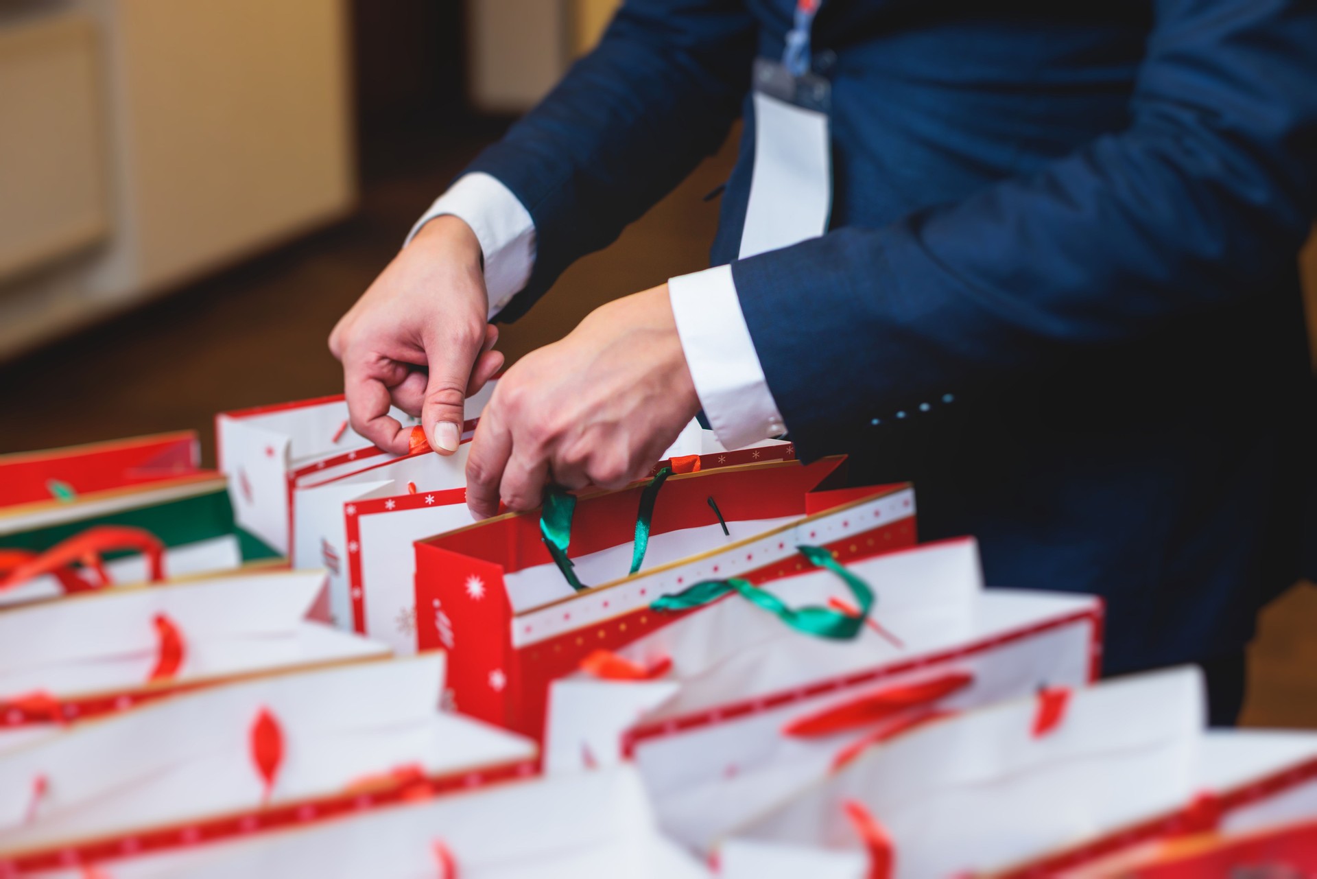New Year corporate gifts and souvenirs for company employees, Christmas party surprise gift bag, gift giving at office work, red green and white paper bags, presents exchange with colleagues at work