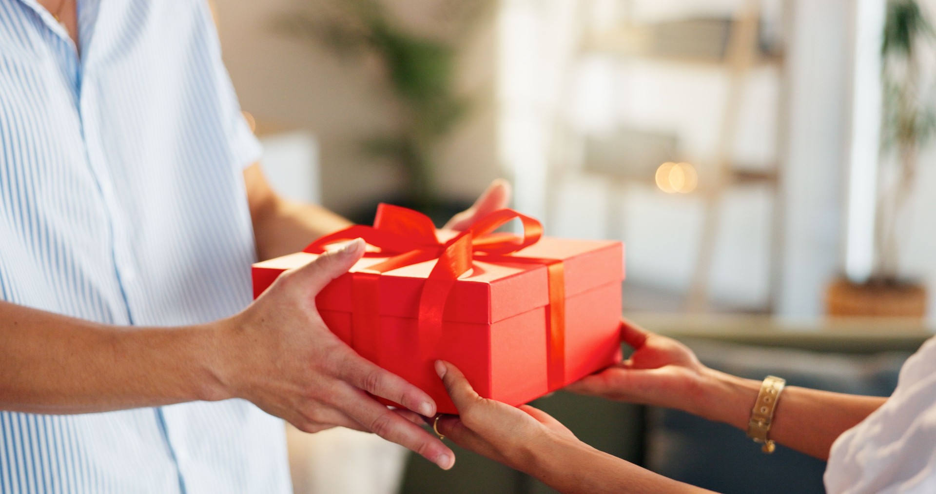 Love, gift and giving with hands of couple for valentines day celebration, box or bonding. Relationship, care and romance with man and woman at home for support, connection or present together